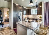 Thumbnail 14 of 18 - Grand Prairie Apartments for Rent - Kitchen With Stainless Steel Appliances, Sleek Cabinetry and Modern Finishes