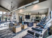 Thumbnail 10 of 18 - Apartments for Rent Grand Prairie TX - Fitness Center With Weight Machines, Cardio Machines, TV and Seating Area
