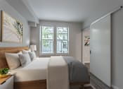 Thumbnail 24 of 42 - a bedroom with a large bed and a large window