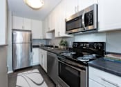 Thumbnail 1 of 19 - Hinton Height_Cottage Grove_MN_a kitchen with stainless steel appliances and white cabinets
