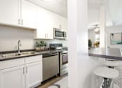 Thumbnail 5 of 19 - Hinton Height_Cottage Grove_MN_a kitchen with stainless steel appliances and white cabinets