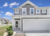 Thumbnail 19 of 19 - Exterior of townhome with two-car garage in Poplin Meadows, pet-friendly townhome community in Indian Trail, NC