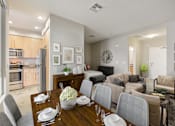 Thumbnail 3 of 18 - A modern dining room with a wooden table set for six.