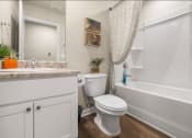 Thumbnail 16 of 30 - a bathroom with a toilet and a tub and a sink