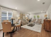 Thumbnail 5 of 30 - a living room with couches and chairs and a table