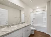 Thumbnail 19 of 30 - a bathroom with two sinks and a shower and a toilet
