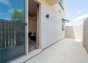 Thumbnail 13 of 20 - A modern house with a glass door and a tiled wall.