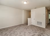 Thumbnail 38 of 38 - A room with a carpeted floor and a white door.