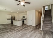Thumbnail 28 of 38 - A spacious kitchen with a staircase leading to the upper floor.