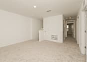 Thumbnail 26 of 75 - A room with white walls and carpeted floor.