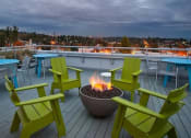 Thumbnail 12 of 20 - Apartments for Rent in South Seattle, WA - Greenhouse - Rooftop Fire Pit and Sundeck with Views of Downtown and Lake Washington.
