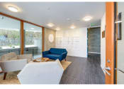 Thumbnail 47 of 54 - Apartments in Seattle for Rent-Inspire Fremont- Lobby with Windows, Lounge Seating, and Overhead Lighting