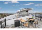 Thumbnail 49 of 54 - Apartments in Fremont, WA for Rent - Inspire Fremont - Rooftop with Solar Panels, Outdoor Seating, and View of the City