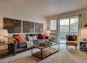 Thumbnail 19 of 47 - Apartments for Rent Spokane WA - Canyon Bluffs - Furnished Living Room with Plush Carpeting, a Sliding Glass Door to a Private Patio/Balcony, Stylish Decor, and a Window