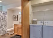 Thumbnail 23 of 47 - Spokane Apartments - Canyon Bluffs - Washer-and-Dryer in a Closet with Storage Space Next to Bathroom