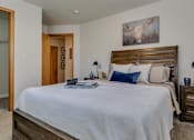 Thumbnail 26 of 47 - Apartments for Rent Spokane - Canyon Bluffs - Bedroom with Plush Carpet, a Bed, Nightstands, and a Spacious Closet