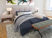 Thumbnail 10 of 66 - A bedroom with a large bed and a bench in front of it.