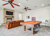 Thumbnail 10 of 33 - Game room with couch to watch tv and ceiling fan and pool table