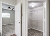 Thumbnail 8 of 33 - an empty closet with a ceiling fan and a white closet door