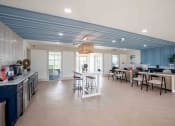 Thumbnail 4 of 19 - a kitchen and dining room with tables and chairs