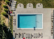 Thumbnail 13 of 21 - Swimming pool at Hawks Landing Apartments in Hickory, NC with concrete deck and lounge chairs