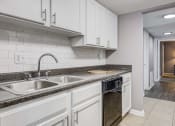 Thumbnail 2 of 29 - Westchase Apartments in Harvey LA photo of a kitchen with white cabinets and a sink