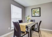 Thumbnail 4 of 29 - Westchase Apartments in Harvey LA photo of a dining room with a table with chairs and a vase of flowers