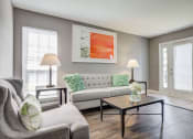 Thumbnail 6 of 29 - Westchase Apartments in Harvey LA photo of a living room with a couch and a table and hardwood floors