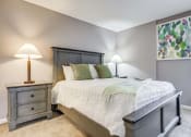Thumbnail 7 of 29 - Westchase Apartments in Harvey LA photo of a bedroom with a bed and two lamps