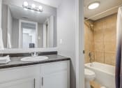 Thumbnail 9 of 29 - Westchase Apartments in Harvey LA photo of a bathroom with a sink and a toilet and a mirror