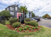 Thumbnail 28 of 29 - Westchase Apartments in Harvey LA photo of the property's monument sign with flowers