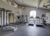 Thumbnail 24 of 29 - Westchase Apartments in Harvey LA photo of fitness center with cardio equipment and strength training