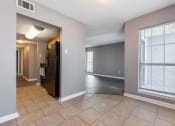 Thumbnail 14 of 29 - Westchase Apartments in Harvey LA photo of an empty living room with a large window and tile flooring