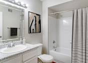 Thumbnail 15 of 39 - A white bathroom with a toilet, sink, and shower.