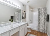 Thumbnail 13 of 39 - A bathroom with a white sink and a white toilet.