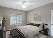 Thumbnail 8 of 39 - A bedroom with a bed, chair, and ceiling fan.
