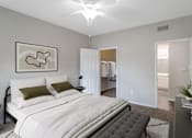 Thumbnail 9 of 39 - A bedroom with a large bed and a painting on the wall.