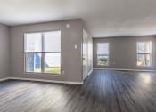 Thumbnail 21 of 33 - Whitney Manor Apartments in Gretna, LA photo of  an empty living room with wood floors and a window