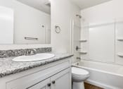 Thumbnail 8 of 33 - Whitney Manor Apartments in Gretna, LA photo of bathroom with sink, toilet and bathtub