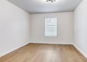 Thumbnail 6 of 33 - Whitney Manor Apartments in Gretna, LA photo of  bedroom with hardwood flooring and a window