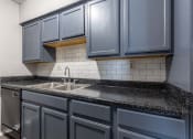 Thumbnail 19 of 33 - Whitney Manor Apartments in Gretna, LA photo of kitchen with subway tile backsplash