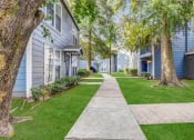 Thumbnail 32 of 33 - Whitney Manor Apartments in Gretna, LA photo of community buildings with greenery in between