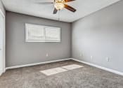 Thumbnail 15 of 33 - Whitney Manor Apartments in Gretna, LA photo of bedroom with plush carpeting and ceiling fan