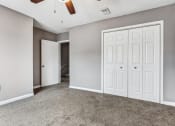 Thumbnail 14 of 33 - Whitney Manor Apartments in Gretna, LA photo of bedroom with plush carpeting and ceiling fan