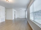 Thumbnail 5 of 33 - Whitney Manor Apartments in Gretna, LA photo of  an empty living room with a large window and wood flooring