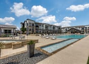 Thumbnail 13 of 25 - Resort-style pool deck at apartments in North Georgetown TX near I-35 corridor