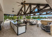 Thumbnail 16 of 25 - Outdoor kitchen and grilling area at Williamson County apartments Georgetown TX