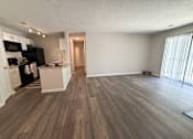Thumbnail 10 of 25 - A kitchen with black appliances and a wooden floor.