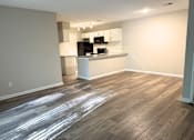 Thumbnail 3 of 25 - A kitchen area with a countertop and cabinets.