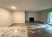 Thumbnail 5 of 25 - A room with a fireplace and a rug on the floor.
